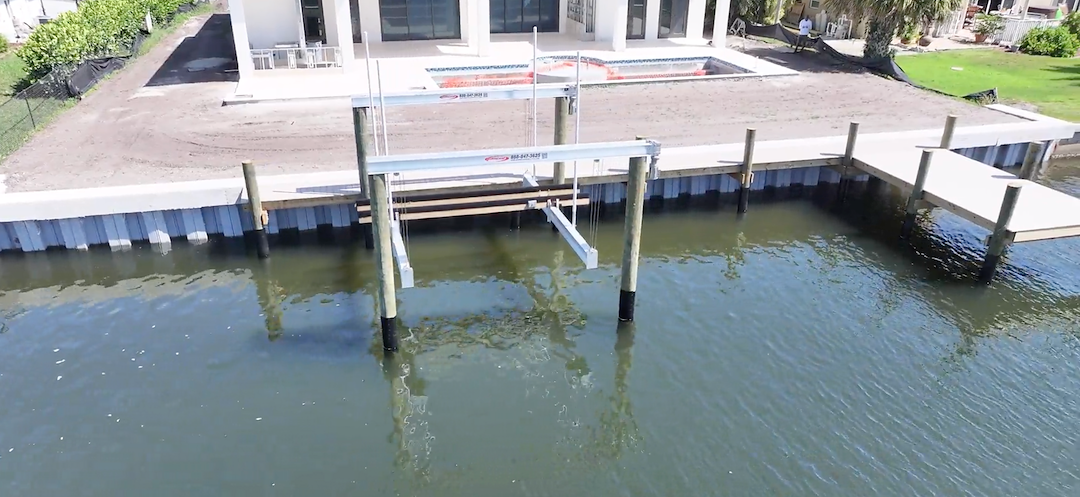 Installation of a New Vinyl Seawall and Concrete Cap, Dock with Vinyl Decking, and Hurricane Boat Lift 24,000lb. with Piles