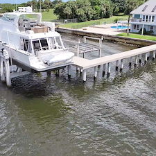 Premium-Aluminum-Dock-with-Concrete-Piles-Vinyl-Decking-and-120000-lb-Hi-Tide-Boat-Lift-Installation-in-Stuart-FL 1